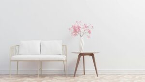 diy decor home -Elegant minimalist living room featuring a cozy sofa and table with floral decor.